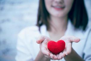 cute girl teen giving love heart and smile photo