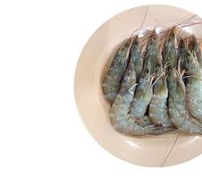 Close up Fresh raw shrimp on pink plate.Top view. isolated on white background with clipping path photo