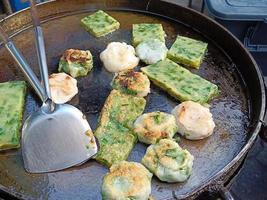 Fried Garlic chives cake on pan are sale at the flea market. photo