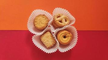 shapes of cookies in stack on red background photo