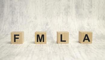 FMLA family medical leave act symbol. Concept words FMLA family medical leave act on wooden cubes photo