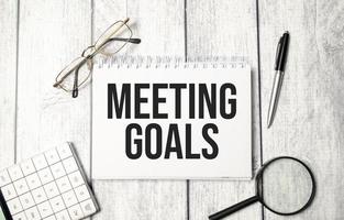 MEETING GOALS word on notebook and calculator photo