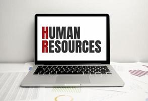 human resources words on laptop display and charts photo