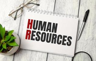 human resources word on notebook and calculator photo