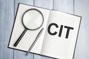 CIT. magnifier on brown notepad text on magnifier glass photo