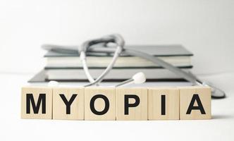 top view blocks with word MYOPIA on the wooden background photo