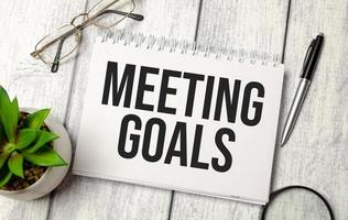 MEETING GOALS word on notebook and calculator photo