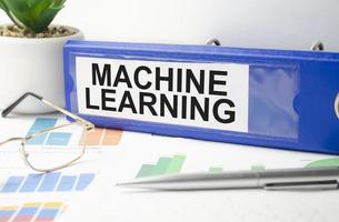 machine learning text written on folder with documents photo