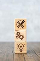 wood block with business goal, strategy, target, mission, action, objective, teamwork and idea concept photo