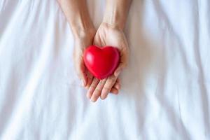 Woman holding Red heart shape on white background. Healthcare, life Insurance, donation, health and World Heart Day concept photo