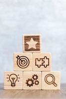 wood block with business success, goal, strategy, target, mission, action, objective, teamwork, research and idea concept photo