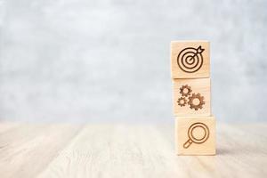 wood block with business goal, strategy, target, mission, action, objective, teamwork, brainstorm and idea concept photo