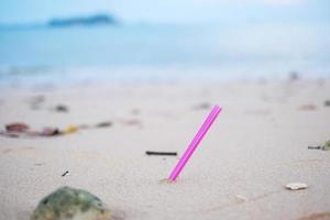 plastic Straw garbage on the beach. Ecology,  Environmental, pollution and Ecological problem concept photo