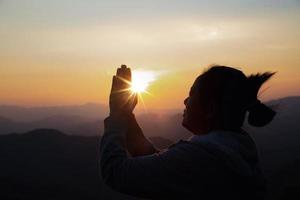 woman worship on sunset photo