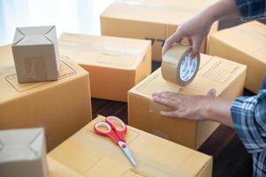 Closeup view of female packing package shipping box photo