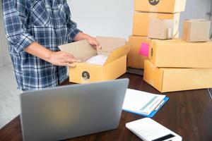 Closeup view of female packing package shipping box photo