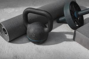 Kettlebell and yoga mat on the floor at home. gym equipment. photo
