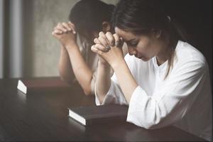 Woman praying and bible concepts, beliefs and Christian faith at church. photo