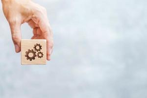 hand hold gear block with business goal, strategy, teamwork, target, mission, action, objective, brainstorming  and success concept photo