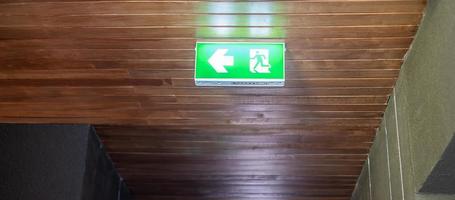 Fire Emergency exit sign on the wall background inside building. Safety concept photo