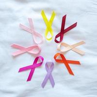 World cancer day. colorful awareness ribbons red, orange, purple, pink, peach and yellow color for supporting people living and illness. Healthcare and medical concept photo