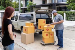 The courier checks the goods before delivering them to the homeowner. Carrying things into a new home. photo