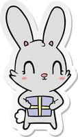 sticker of a cute cartoon rabbit with present vector