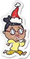 distressed sticker cartoon of a woman wearing spectacles wearing santa hat vector