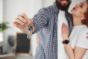 Dream come true. Happy couple together in their new house. Conception of moving photo