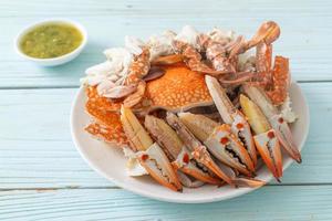 Steamed blue crab with spicy seafood sauce photo