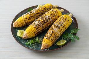 barbecue and grilled corn with cheese and lime photo