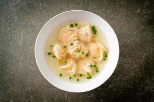 shrimp dumpling soup in white bowl photo