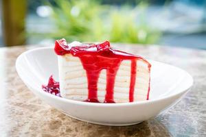 vanilla crepe cake with raspberry and strawberry sauce photo