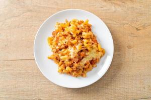 homemade macaroni bolognese with cheese photo