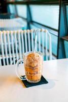 Thai tea ice scoop in glass photo