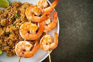 fried rice with shrimps skewers photo
