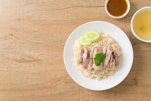 Hainanese Chicken Rice or steamed rice with chicken photo