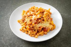 homemade macaroni bolognese with cheese photo