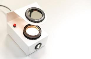 The Gemologist expertise in her laboratory fix the value of precious stone of the polariscope. photo