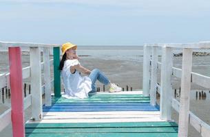 The asian woman sitting on the rainbow bridge to see the viewpoint at the Samut Sakorn province, one of the province in Thailand. photo