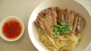 dried noodles with stewed duck in white bowl - Asian food style video