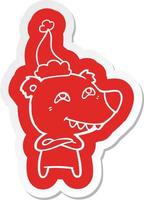 cartoon  sticker of a bear showing teeth wearing santa hat vector