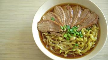 egg noodles with stewed duck in brown soup - Asian food style video