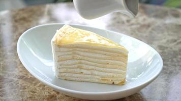 vanilla crepe cake with raspberry and strawberry sauce on plate video