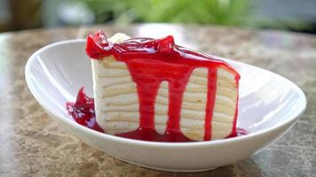 vanilla crepe cake with raspberry and strawberry sauce on plate video