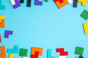 colorful wood puzzle pieces on blue background, geometric shape block with copy space. Concepts of logical thinking, Conundrum, solutions, rational, strategy, world logic day and Education photo