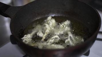 Woman frying tempura of cod buds video