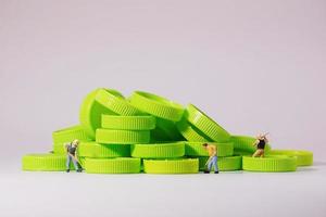 Worker figure standing on plastic cap. Recycle material concept. photo