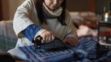 Image of a woman ironing video