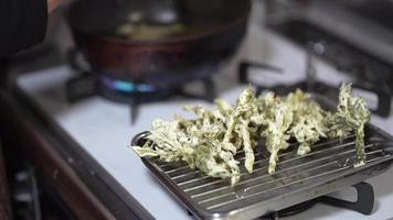 Woman frying tempura of cod buds video